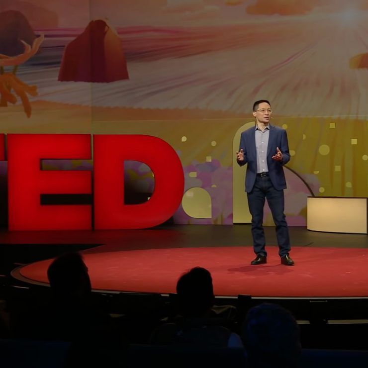 Eric Liu standing on the TED Talks stage.