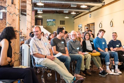 A group of people who are seated and chatting with one another.