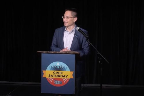 Eric Liu standing at a Civic Saturday podium and speaking.