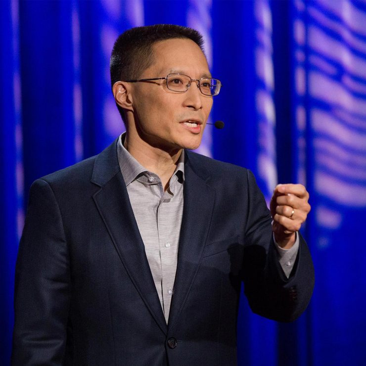Eric Liu speaking to a crowd from a stage with a Civic Saturday podium.