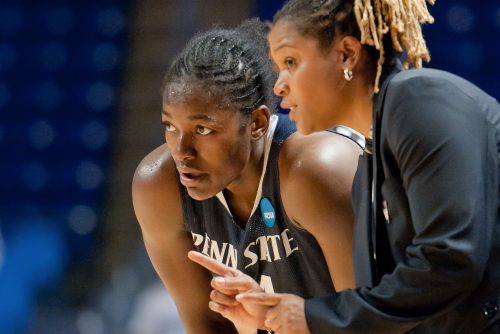 A basketball player and their coach discussing a play.