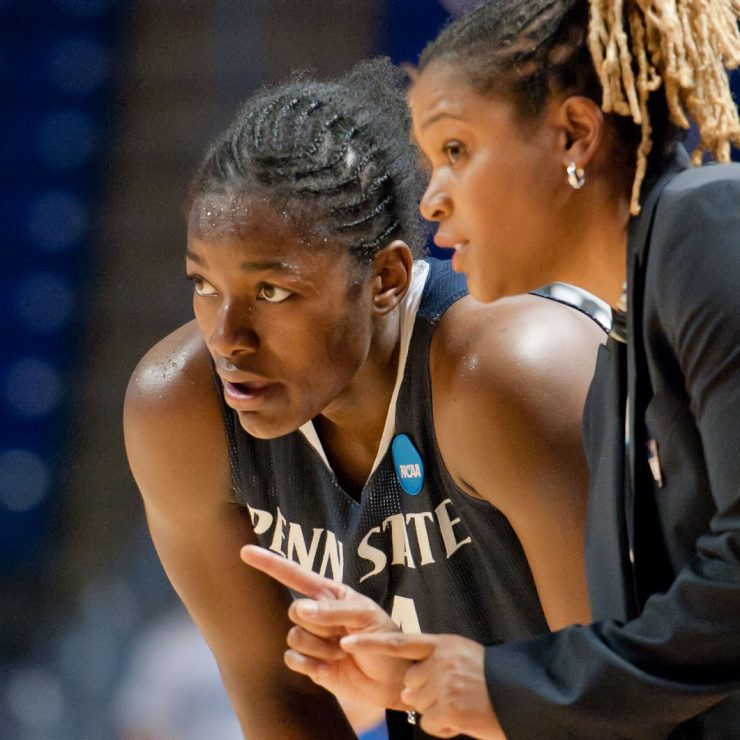 A basketball player and their coach discussing a play.