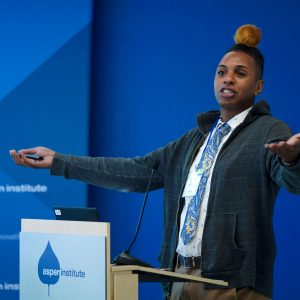 A person presents at the front of a room.