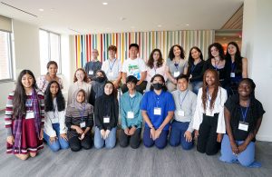 A group of two dozen young people posing for the camera.