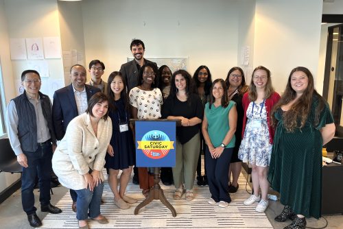 A group of civic saturday fellows smiling together.