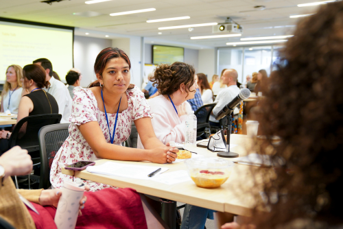 A candid image of Anishka Durvasula sitting at a table. 