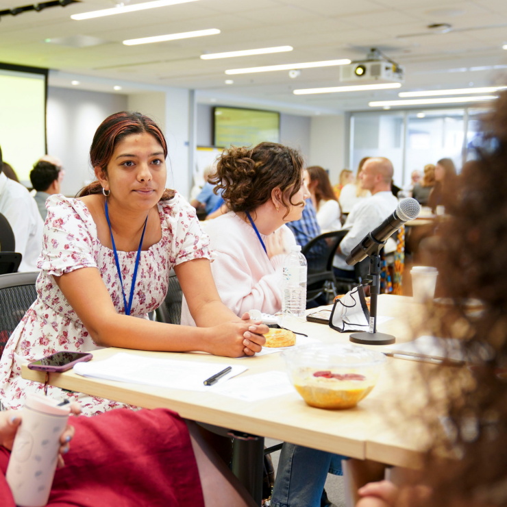 A candid image of Anishka Durvasula sitting at a table. 