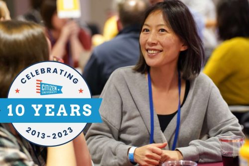 A logo for 10 years of CU on an image of a woman smiling at a table