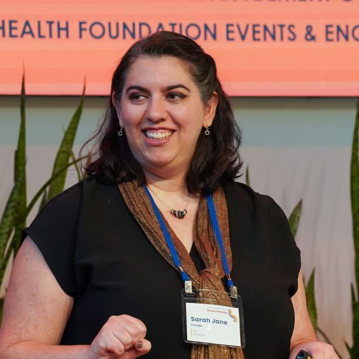 A photo of Sarah Jane speaking on a stage.