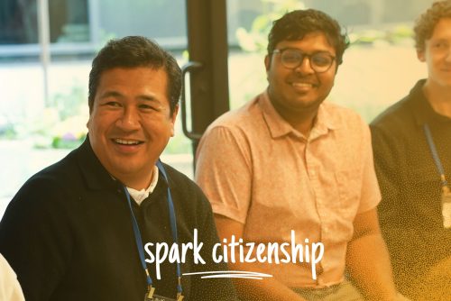 Three people sitting and smiling together, with the text, spark citizenship.
