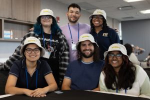 A small group smiling at a table
