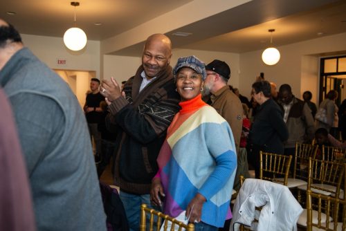Two people standing together and smiling 