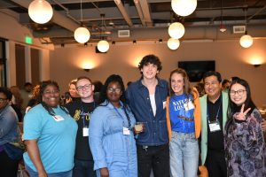 A group standing together and smiling.