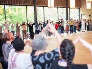 A person sitting in a group and smiling.