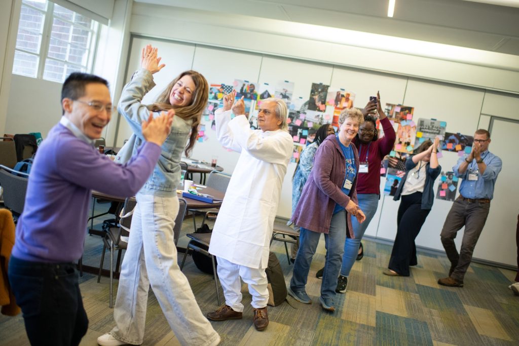 A row of people dancing together.