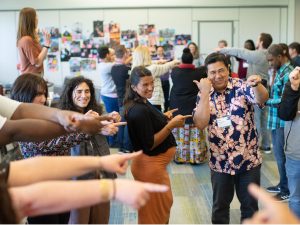 Two people sitting at a table, one is talking and one is listening.