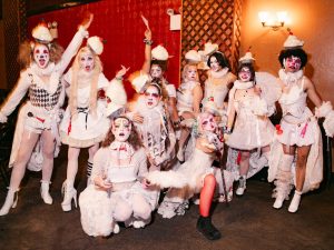 An image of The Debt Gala performers standing onstage.